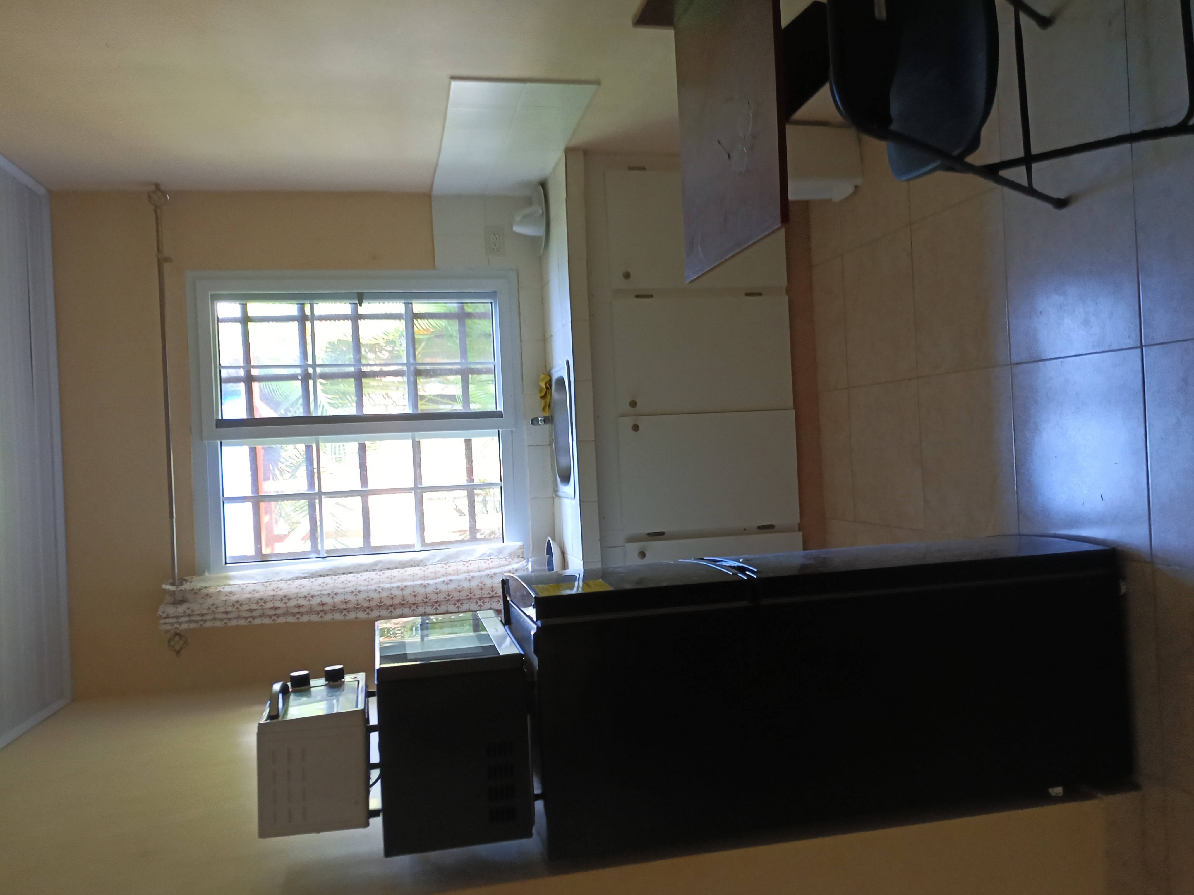 Kitchen with black fridge and dining area