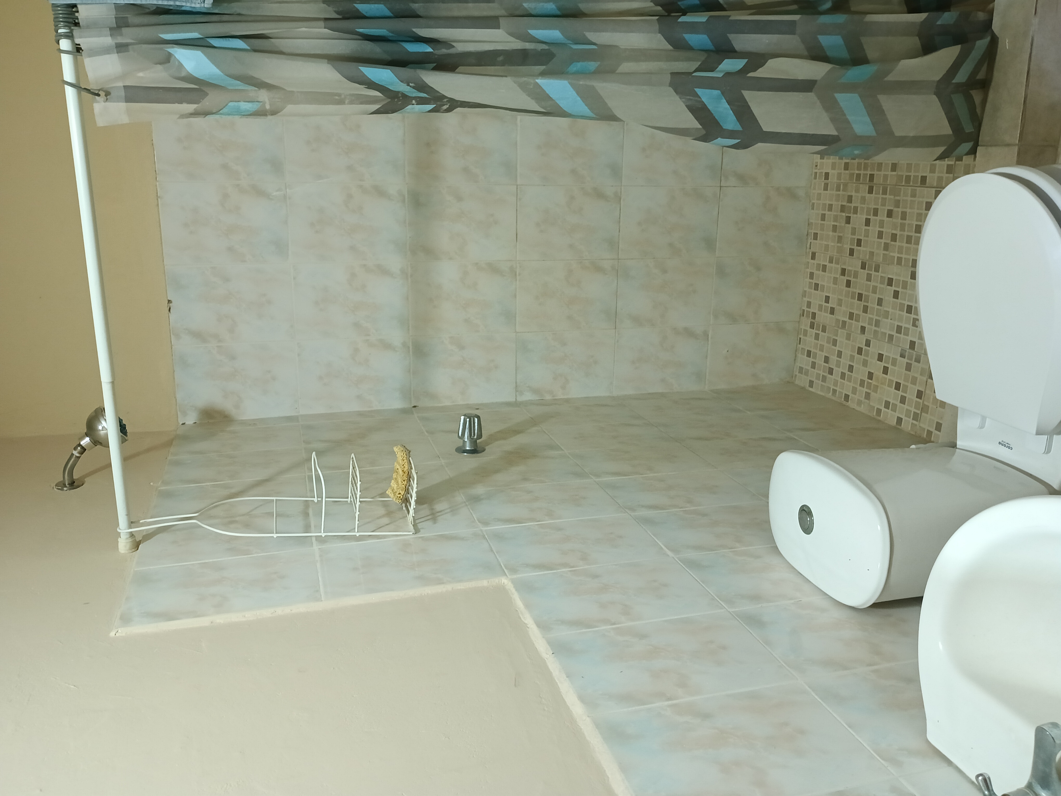 Bathroom with shower and mosaic tiles