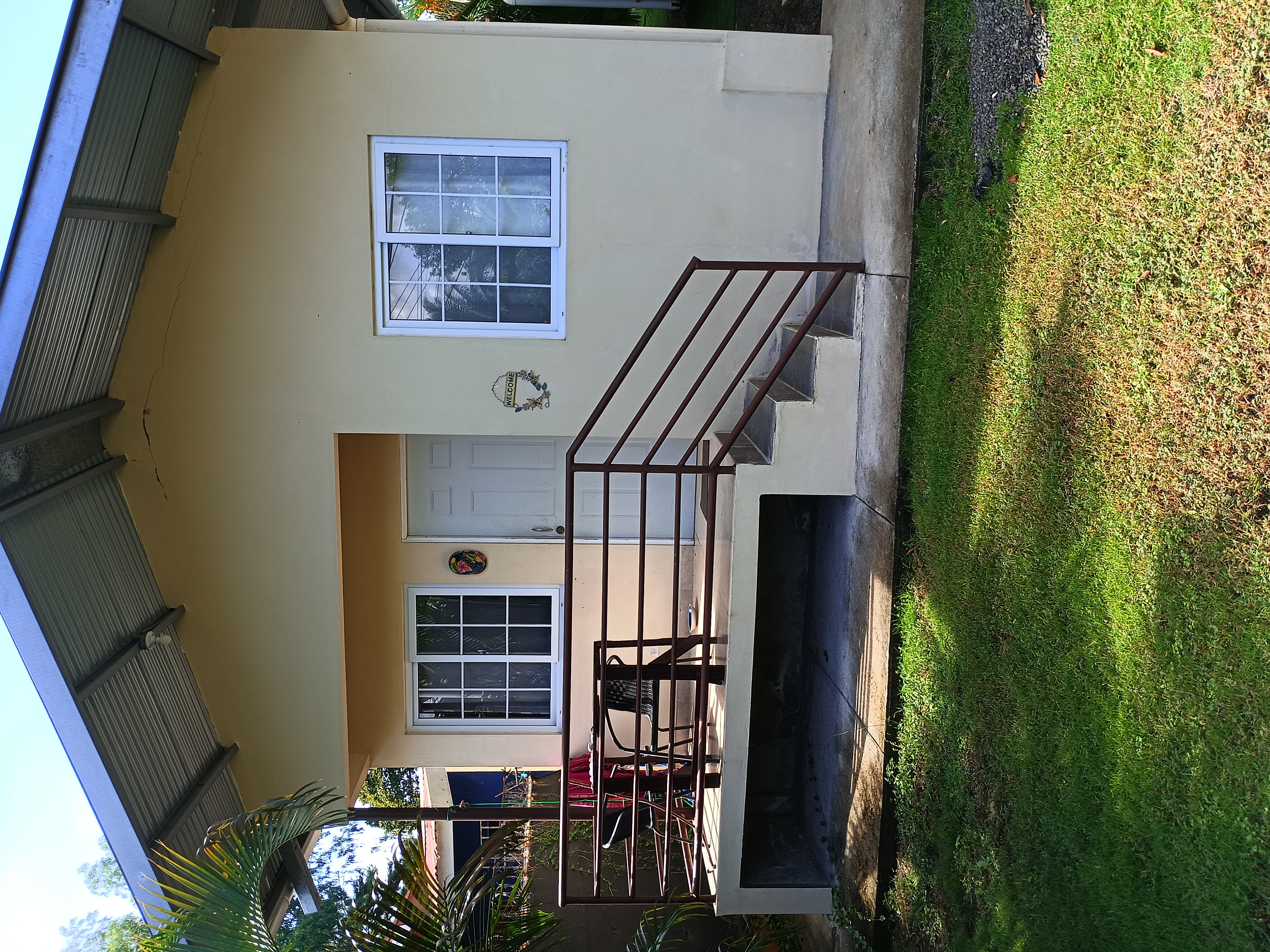 Punta Barco Apartments exterior with deck and tropical garden