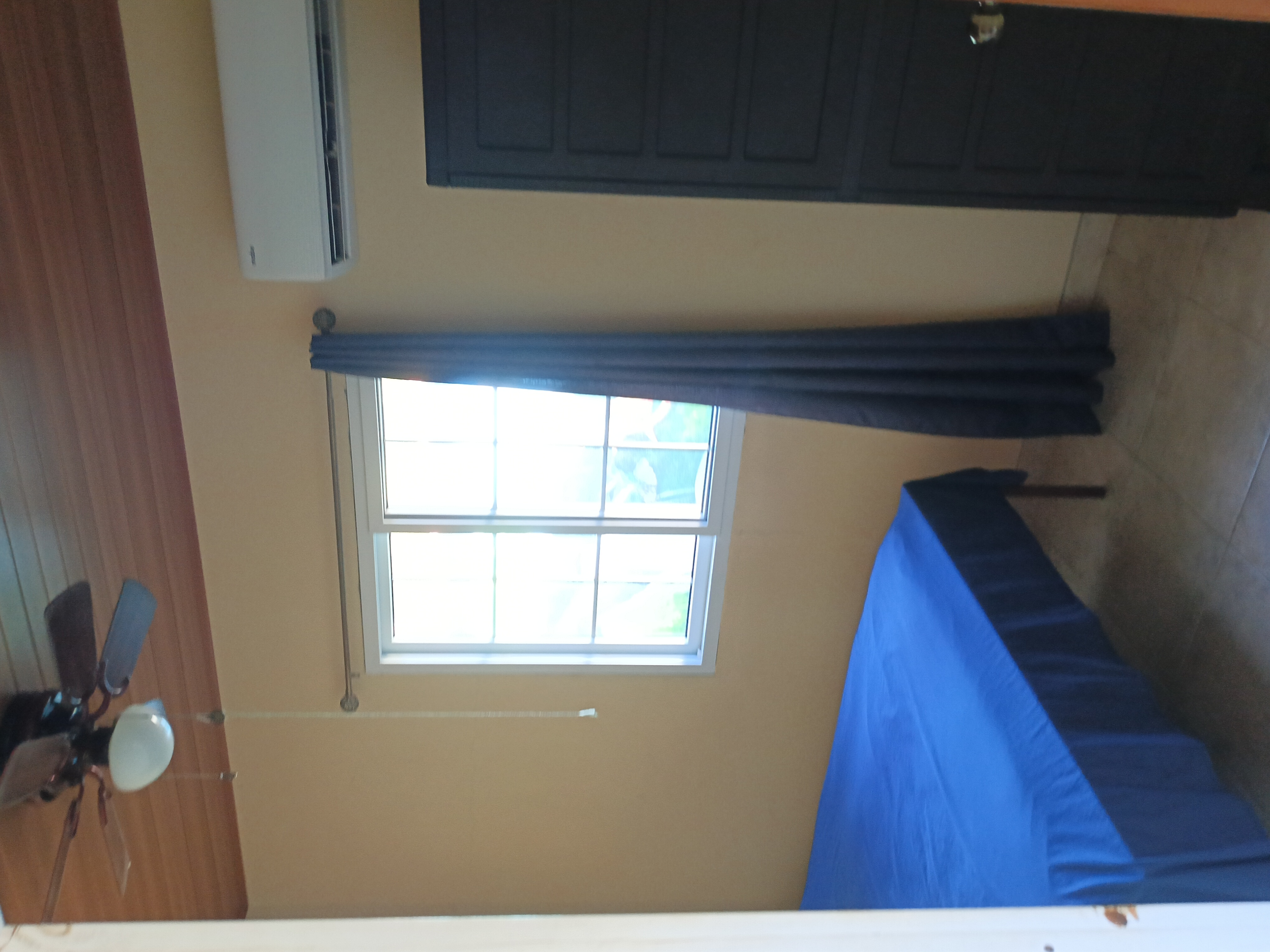 Bedroom with AC and ceiling fan